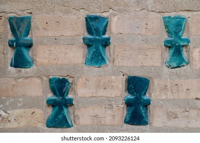 Turquoise tiles in the shape of a Zoroastrian fertility symbol, in Khiva, Uzbekistan
