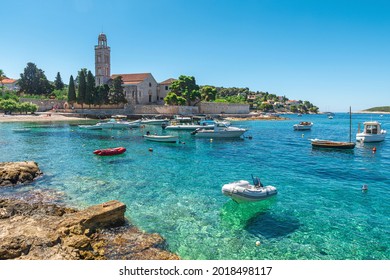 Turquoise water of Adriatic sea bay on Hvar island with franciscian monastery and boats in Dalmatia region, Croatia. Summer vacation destination