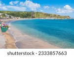 Turquoise water of the bay of Praia da Vitória with marina and hill with the Facho viewpoint in the background in Porto Martins, Terceira - Azores PORTUGAL