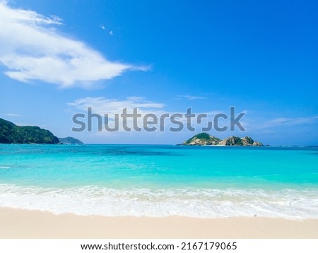 Turquoise water, clear sky, white sandy beach, and the tropical Caspian Sea