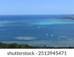 Turquoise waters, coral reed and sail boats in Kaneohe Bay, Oahu, Hawaii