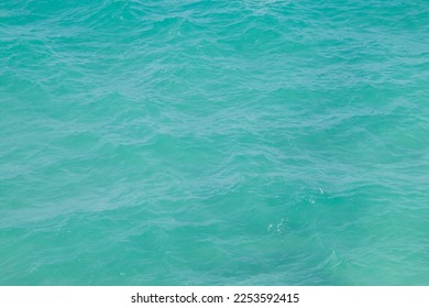 Turquoise waters on a white sand beach. Rippled surface of sea water observed from the top of a cliff in Torre dell'Orso, Puglia, Italy. - Shutterstock ID 2253592415