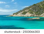 Turquoise waters and rocky shoreline at Two Peoples Bay in Western Australia, near Albany. Perfect for projects featuring coastal scenery, travel destinations, or natural beauty themes.