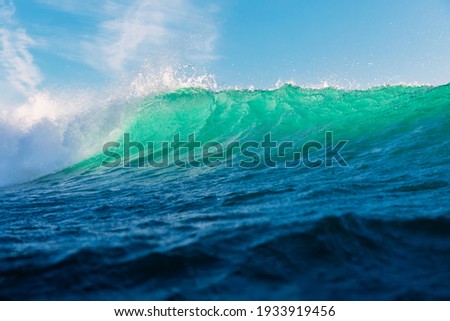 Turquoise waves in ocean. Breaking wave with sun light