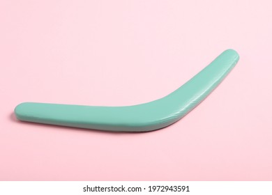 Turquoise Wooden Boomerang On Pink Background. Outdoor Activity