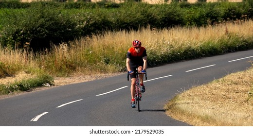 Turvey, Beds, UK - July 16th 2022. Lycra Clad Cyclist On A Country Road