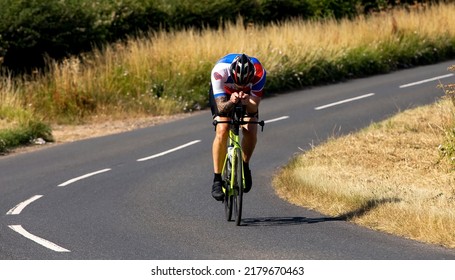 Turvey, Beds, UK - July 16th 2022. Cyclist Dressed In Lycra Using Aero Bars