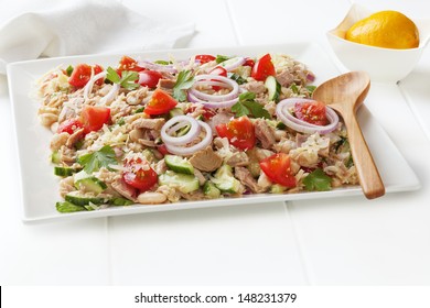 Tuscan Bean And Tuna Salad With Tomatoes, Cucumber, Parmesan And Lemon Vinaigrette, On A Square White Platter.
