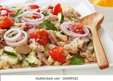 Tuscan Bean And Tuna Salad With Tomatoes, Cucumber, Parmesan And Lemon Vinaigrette, On A Square White Platter.