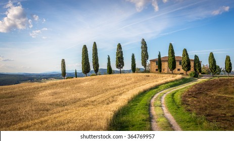 Tuscan Landscape With Farmhouse And Cypress Trees