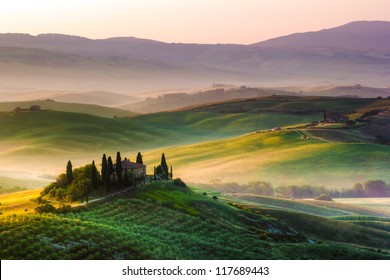Tuscan morning, italian landscape. Farmhouse and hills.