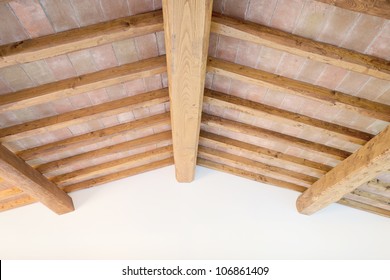 Tuscan Traditional Oak Wood Beam Ceiling, Red Bricks Pattern And Wall On Background. Classic Italian Rural Interiors.