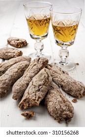 Tuscany Italian Cookies and two glasses of vinsanto dessert wine on wooden white table