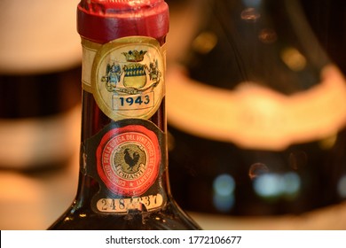 Tuscany, Italy-July 2020; Close up view of the neck of a bottle of Chianti wine from the vintage 1943 with the well known seal of the wine consortium with the black rooster