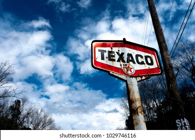 Tuscumbia, Alabama / USA - February 20 2018: Rusted, Bullet-Ridden Texaco Sign Aged by the Years and Neglect