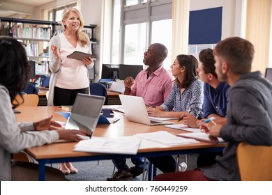Tutor With Group Of Mature College Students Working In Library - Shutterstock ID 760449259