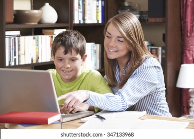 Tutor Helping Boy Studying At Home