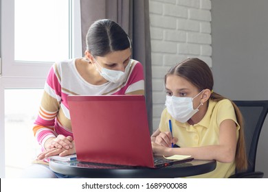 The Tutor At Home In A Medical Mask Explains To The Girl The Course Of Solving Homework