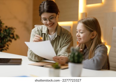 Tutor in a private lesson with a small child of a girl.