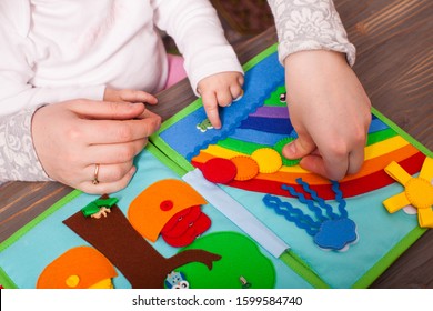 Tutor with toddler are learning the colors of the rainbow