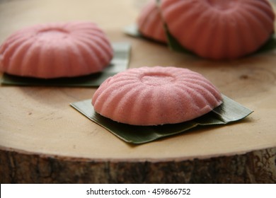 Tutu Kueh. Steamed Rice Flour Bun Then Underlined With Pandanus Leaf, Arranged On Natural Wooden Board.