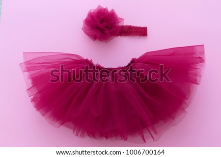 Tutu pink, purple, skirt with flower headband for newborn girl. Concept of children's clothing.