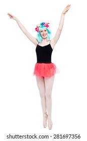 Tutu wearing ballet girl with arms up on pointy toes.