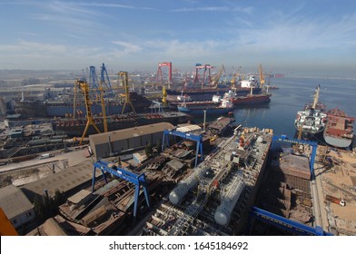 Tuzla shipyard and harbor. Tanker and winches, Istanbul, Turkey, February 2020; Logistics and Container Cargo ship and working crane bridge in shipyard