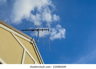 The Tv Antenna Is Installed Up On The Top Roof Of The House.