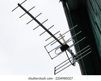 TV Antenna On Old Wooden Rural House Roof