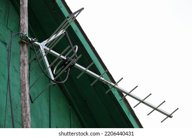 TV Antenna On Old Wooden Rural House Roof