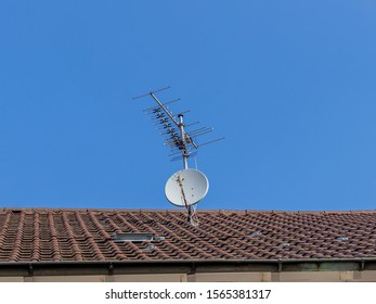 TV Antenna With Parabolic Antenna On A Roof