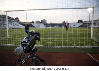 TV Camera Behind The Football Goal At The Stadium During Football Matches