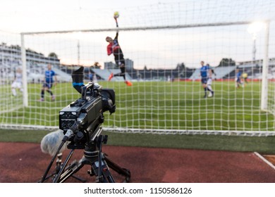 TV Camera Behind The Football Goal At The Stadium During Football Matches