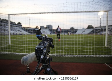 TV Camera Behind The Football Goal At The Stadium During Football Matches