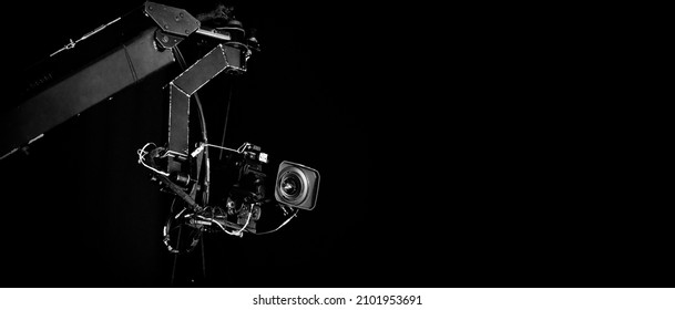 TV Camera broadcast on the crane tripod for shooting or recording and broadcasting content in studio production to on air tv or online internet live show. HD Video recording on crane. Selective focus.