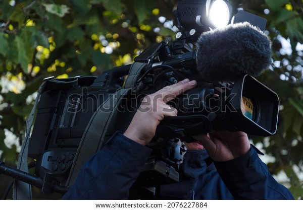 TV\
CAMERA - Cameraman when recording reportage materials\
