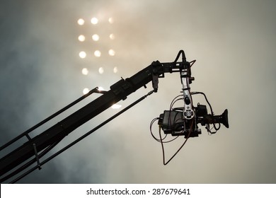 TV camera on a crane on football mach or concert