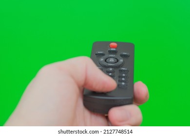 TV Control Panel In A Male Hand On A Green Background