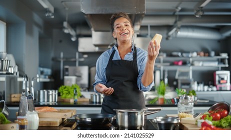 TV Cooking Show in Restaurant Kitchen: Portrait of Black Female Celebrity Chef Talks, Teaches Fun Way How to Cook Food. Online Video Courses, Learning Video Lectures. Healthy Dish Recipe Preparation - Powered by Shutterstock