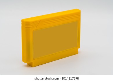 TV Game Cartridge In Plastic Yellow Case From 90s Isolated On White Background.  Selective Focus