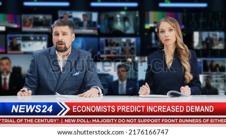 TV Live News Program: Two Presenters Reporting, Discuss Daily Events, Discuss Business, Economy, Science, Entertainment. Television Cable Channel Diverse Anchors Talk. Newsroom Studio Concept.