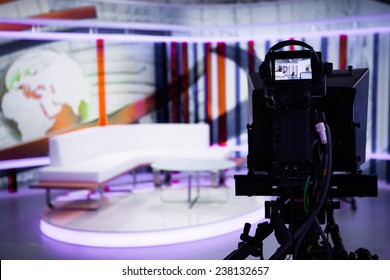 TV Morning Program Studio With Camera And Lights. Video Camera Lens - Show In TV Studio. Television Studio With Interior And And Positioned Camera .