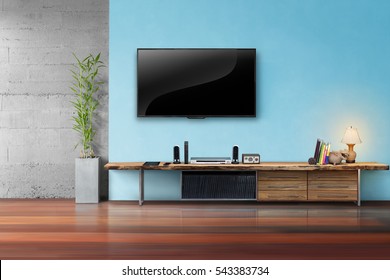 Tv On Light Blue Wall With Wooden Table And Plant In Pot Living Room Interrior