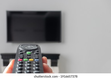TV remote control close-up. blurred background, TV on the background
