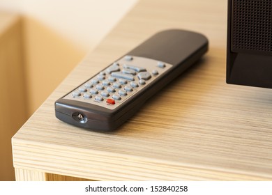 TV remote control lying on the counter, visible part of the TV.