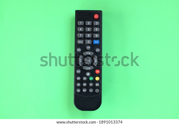 TV remote isolate on green background.concept of\
watching TV