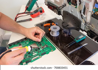 TV Repair In The Service Center, Engineer Soldering Electronic Components