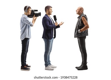 TV Reporter And A Cameraman Interviewing A Bald Punk Rocker Isolated On White Background