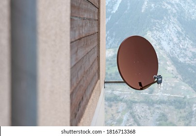 TV Sattelite Dish Mounted On A Wooden House Wall, Rusted Dish